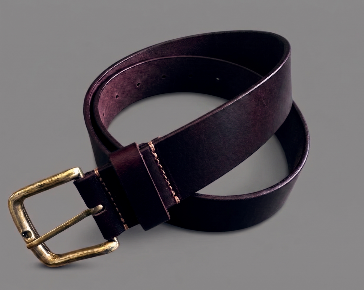 Brown leather belt with a brass buckle on a gray background