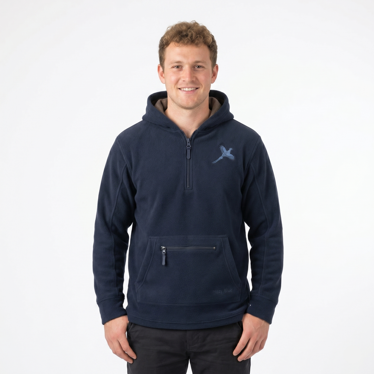 Man wearing a navy blue pullover with a logo on a white background