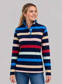 Woman wearing a multicolored striped shirt against a gray background