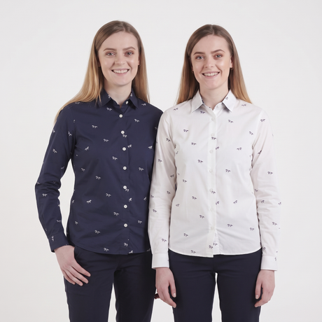 Two women modeling long-sleeve button-up shirts with a small repeating bird print. The shirt on the left is navy blue, and the shirt on the right is white.