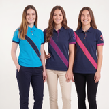 Three women modeling short-sleeve polo shirts with diagonal color-blocked stripes, standing against a plain white studio background. The shirts feature different colorways: one bright blue and navy, one navy and purple, and one navy and pink.