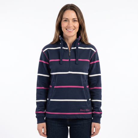 A woman modeling a navy blue half-zip hoodie with horizontal white and pink stripes, featuring a drawstring hood and a front kangaroo pocket, set against a plain white background.