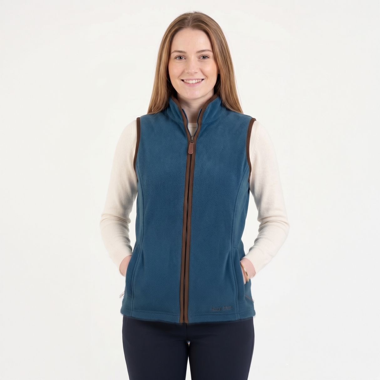 Woman wearing a blue fleece vest with a white background