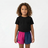 Child wearing a black t-shirt and colorful shorts on a white background