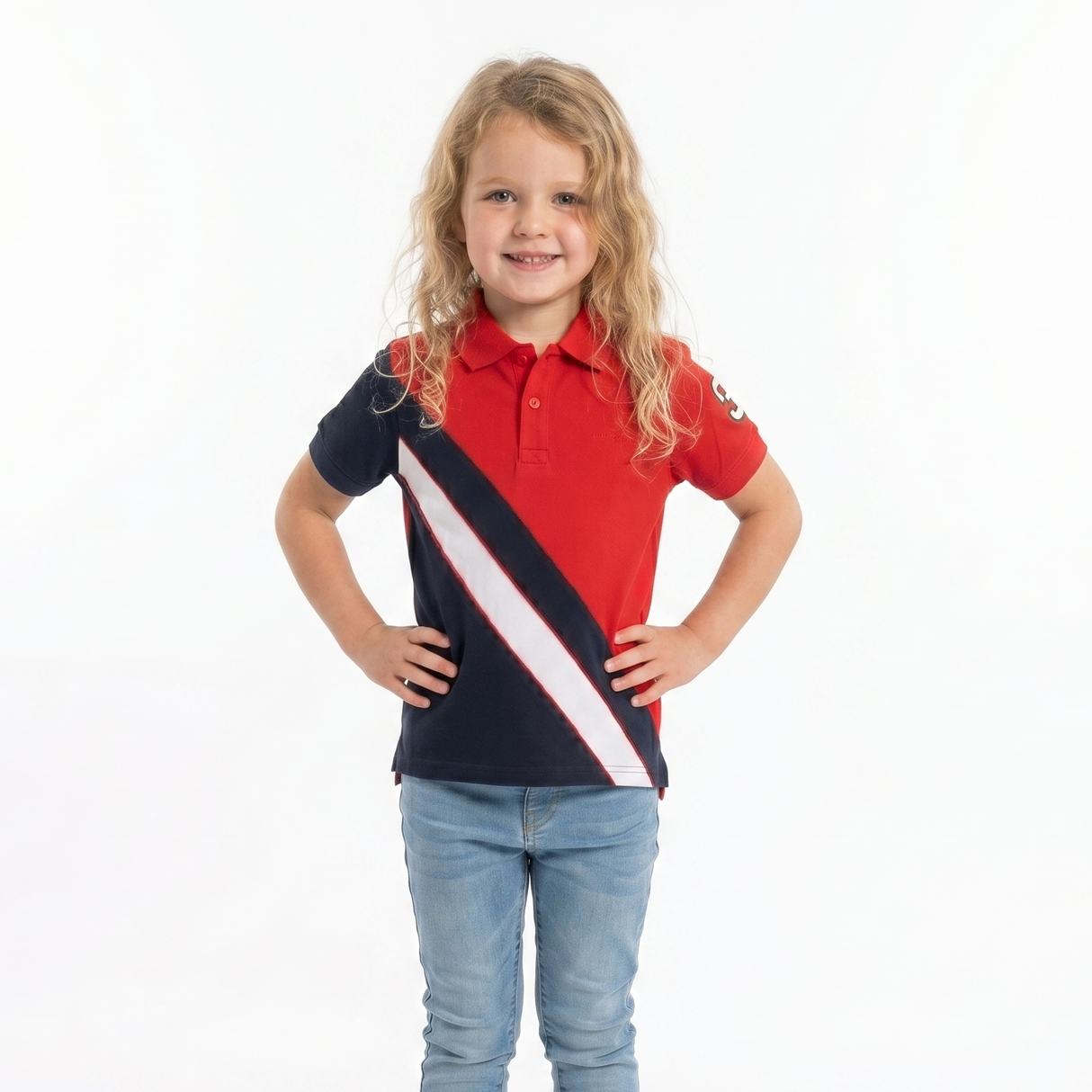 Young girl wearing a red and navy striped polo shirt with blue jeans on a white background