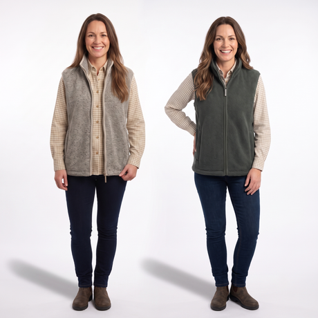 Two women modeling fleece zip-up vests side by side against a white studio background. The vest on the left is heather taupe, and the vest on the right is dark olive green.